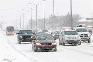 Cars on a highway while snowing