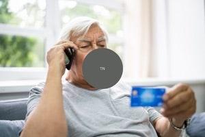 Old man looking at his credit card